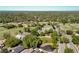 Aerial view of the house, golf course, and road in the neighborhood at 3960 Villas Green Cir, Longwood, FL 32779