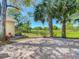 Paver patio overlooking lush green golf course and mature palm trees at 3960 Villas Green Cir, Longwood, FL 32779