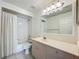 Bright bathroom featuring a tub with shower and a vanity with a large mirror at 3960 Villas Green Cir, Longwood, FL 32779