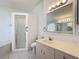 Well-lit bathroom with a walk-in shower, soaking tub and modern fixtures at 3960 Villas Green Cir, Longwood, FL 32779