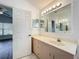 Bathroom with an extended vanity, ample lighting and a view into the Primary bedroom at 3960 Villas Green Cir, Longwood, FL 32779