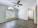 Vaulted bedroom with large window, ceiling fan, and an adjacent entryway at 3960 Villas Green Cir, Longwood, FL 32779