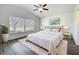 Bedroom with a ceiling fan, plush rug, and large window at 3960 Villas Green Cir, Longwood, FL 32779