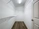 Well-organized closet with shelving on all sides and wood-look flooring at 3960 Villas Green Cir, Longwood, FL 32779