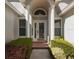 Inviting front entrance with decorative glass door and sidelight windows at 3960 Villas Green Cir, Longwood, FL 32779