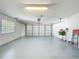 Spacious garage with epoxy floors, a window for natural light, and ample storage at 3960 Villas Green Cir, Longwood, FL 32779