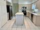 Spacious kitchen with an island, stainless steel appliances, and ample cabinet space for storage at 3960 Villas Green Cir, Longwood, FL 32779