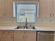 Close-up of the kitchen sink featuring stainless steel appliances and bright natural light at 3960 Villas Green Cir, Longwood, FL 32779