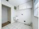 Utility room with white cabinets, a utility sink, tile floor and access to outside at 3960 Villas Green Cir, Longwood, FL 32779