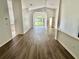 Spacious living room with wood floors, vaulted ceilings, and arched entryway leading to the backyard at 3960 Villas Green Cir, Longwood, FL 32779