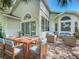 Outdoor patio with dining table and seating plus wicker furniture overlooking lush green golf course at 3960 Villas Green Cir, Longwood, FL 32779