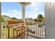 Charming balcony featuring an outdoor wooden bar and stool set, overlooking a landscaped neighborhood at 4622 Eureka Ln, Sanford, FL 32773