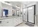 Modern bathroom featuring a double sink vanity, sleek black fixtures, and a glass-enclosed shower at 4622 Eureka Ln, Sanford, FL 32773