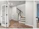 Bright foyer featuring hardwood floors, staircase with modern railing, and a view into other rooms at 4622 Eureka Ln, Sanford, FL 32773