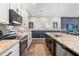 Well-lit kitchen with granite counters, stainless appliances, a kitchen island, and white cabinets at 4622 Eureka Ln, Sanford, FL 32773