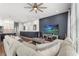 Inviting living room with a ceiling fan, large couch and TV with a coastal screensaver, perfect for relaxation at 4622 Eureka Ln, Sanford, FL 32773