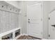 Practical mudroom featuring a built-in bench with storage and coat hooks for organization and convenience at 4622 Eureka Ln, Sanford, FL 32773