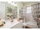 Well-lit bathroom with a neutral color scheme, vanity sink, framed mirror, and decorative butterfly shower curtain at 512 Weston Pl, Debary, FL 32713