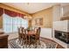 Elegant dining room features a chandelier, fireplace, and large window with decorative valances at 512 Weston Pl, Debary, FL 32713