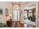 Welcoming foyer boasts a high ceiling, arched windows, and stylish decor leading into a cozy, wallpapered living space at 512 Weston Pl, Debary, FL 32713