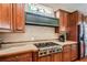 Gourmet kitchen featuring custom cabinetry, stainless steel appliances, tiled backsplash, and a stained glass window at 512 Weston Pl, Debary, FL 32713