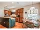 Well-equipped kitchen featuring wood cabinetry, granite countertops, and a cozy breakfast nook with ample natural light at 512 Weston Pl, Debary, FL 32713