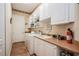 Functional laundry room with a sink, washer, dryer, storage shelves, and ample counter space for folding and organizing at 512 Weston Pl, Debary, FL 32713