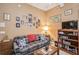 Cozy living room features a comfortable couch, warm lighting, and a curated gallery wall creating an inviting atmosphere at 512 Weston Pl, Debary, FL 32713