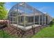 Expansive screened-in pool enclosure showcasing the home's architecture and providing an inviting outdoor living space at 512 Weston Pl, Debary, FL 32713