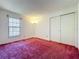 Bright bedroom featuring a window, and closet doors at 7646 Covedale Dr, Orlando, FL 32818