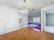 Bright dining area features hardwood floors and a view of the kitchen through an open doorway at 7646 Covedale Dr, Orlando, FL 32818