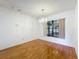 Dining room with hardwood floors and a chandelier with a view to the outside through a window at 7646 Covedale Dr, Orlando, FL 32818