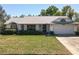 Charming single-story home featuring a well-maintained lawn, attached garage, and neutral color palette at 7646 Covedale Dr, Orlando, FL 32818