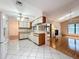 White kitchen flows into living area with fireplace at 7646 Covedale Dr, Orlando, FL 32818