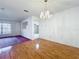 Spacious living room featuring hardwood floors, chandelier, and a bright window at 7646 Covedale Dr, Orlando, FL 32818