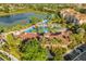 Aerial view of the community pool and waterpark, surrounded by lush landscaping at 7675 Comrow St # 204, Kissimmee, FL 34747