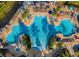 Aerial view of a lagoon style community pool with plenty of seating and shade at 7675 Comrow St # 204, Kissimmee, FL 34747