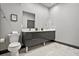 Well-lit bathroom with a dual vanity, a toilet, and marble-look flooring at 7675 Comrow St # 204, Kissimmee, FL 34747