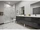 Modern bathroom featuring a marble tile shower, double vanity, and sleek fixtures at 7675 Comrow St # 204, Kissimmee, FL 34747