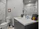 Modern bathroom with a marble-tiled shower, sleek vanity, and elegant fixtures at 7675 Comrow St # 204, Kissimmee, FL 34747