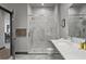 Bathroom with a marble-tiled shower, single vanity, and modern fixtures at 7675 Comrow St # 204, Kissimmee, FL 34747