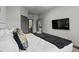 Modern bedroom with a television, ensuite bathroom, and contemporary decor at 7675 Comrow St # 204, Kissimmee, FL 34747