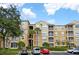 Three-story condo building with manicured landscaping, parking and stairwell to units at 7675 Comrow St # 204, Kissimmee, FL 34747