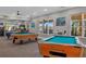 Well-lit recreation area with pool tables and comfortable seating at 7675 Comrow St # 204, Kissimmee, FL 34747