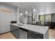 Modern kitchen with stainless dishwasher, quartz counter and pendant lighting. Living room in background at 7675 Comrow St # 204, Kissimmee, FL 34747