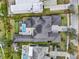 Aerial view of a meticulously landscaped property with a pool, putting green, and elegant design at 8521 Lake Nona Shore Dr, Orlando, FL 32827