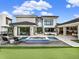 Luxury home boasts a stunning backyard with a pool, spa, outdoor kitchen, patio, and putting green at 8521 Lake Nona Shore Dr, Orlando, FL 32827