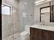 Modern bathroom featuring a glass-enclosed shower and a sleek vanity with contemporary fixtures at 8521 Lake Nona Shore Dr, Orlando, FL 32827