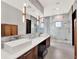 Bathroom featuring double sinks, dark wood drawers, and modern decor at 8521 Lake Nona Shore Dr, Orlando, FL 32827