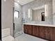 Stylish bathroom featuring a glass-enclosed shower, wood vanity, and modern fixtures at 8521 Lake Nona Shore Dr, Orlando, FL 32827